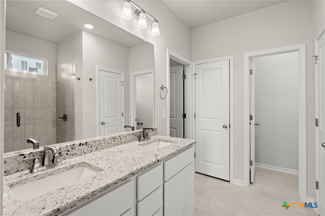 8024 Pineridge Way Temple, TX 76502 - Photo 28 of 32 a bathroom with a granite countertop sink and a mirror