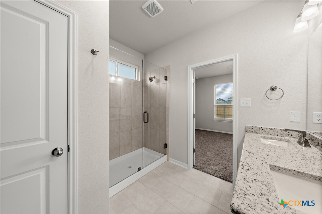 8024 Pineridge Way Temple, TX 76502 - Photo 29 of 32 a spacious bathroom with a granite countertop sink and shower