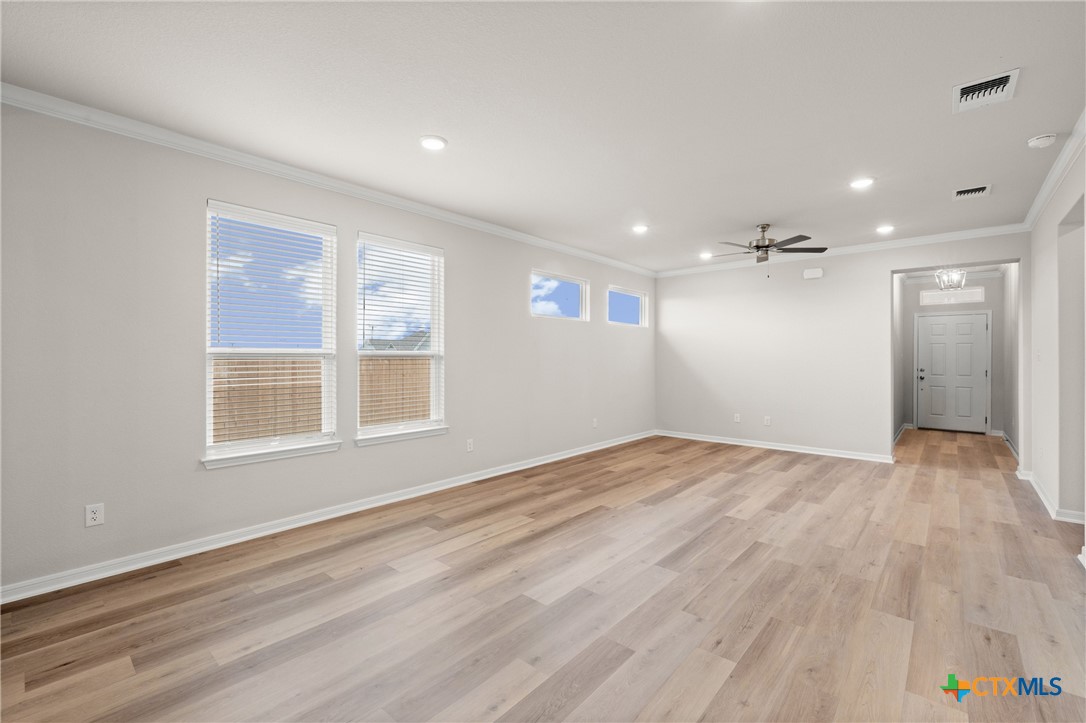 8024 Pineridge Way Temple, TX 76502 - Photo 10 of 32 a view of empty room with wooden floor and windows