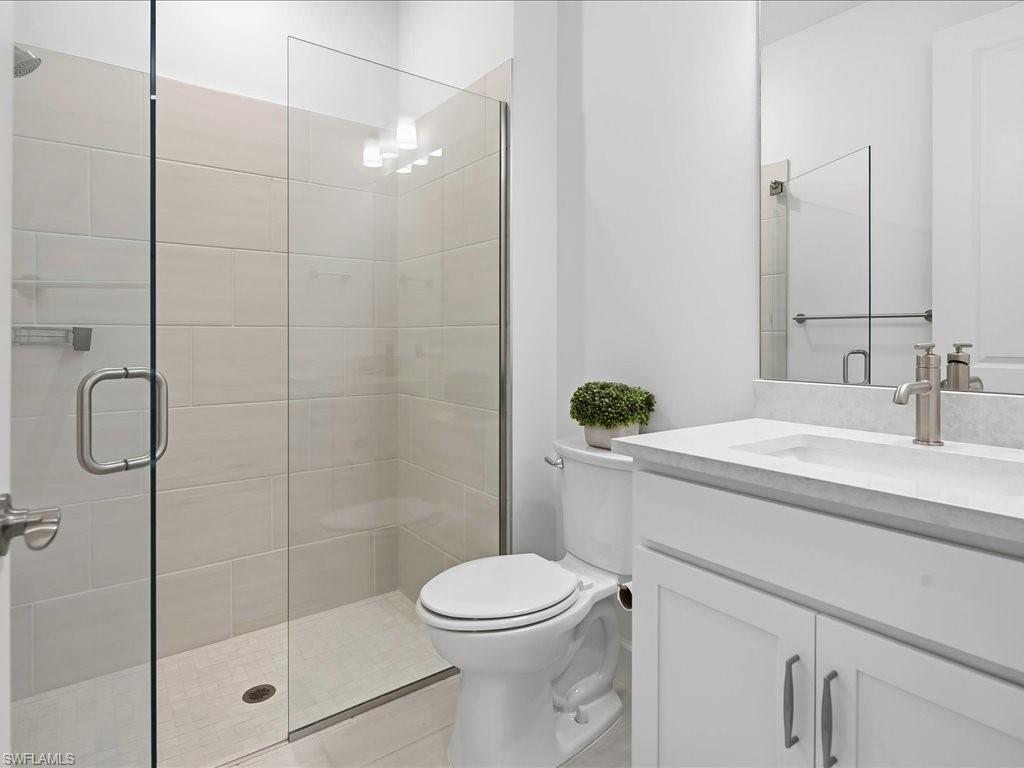 1937 Don Benito Way Naples, FL 34120 - Photo 21 of 27 Full bathroom featuring vanity, a stall shower, and light tile patterned floors