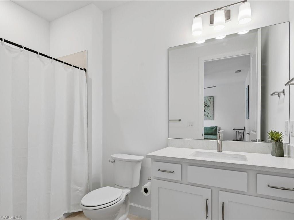 1937 Don Benito Way Naples, FL 34120 - Photo 22 of 27 Bathroom with a shower with curtain and vanity