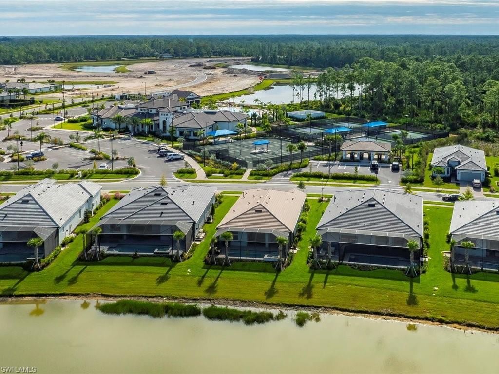 1937 Don Benito Way Naples, FL 34120 - Photo 24 of 27 Aerial view of residential area with a large body of water and a forest