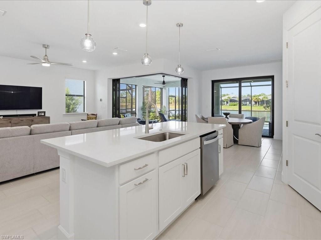 1937 Don Benito Way Naples, FL 34120 - Photo 27 of 27 Kitchen with open floor plan, white cabinets, a ceiling fan, recessed lighting, and decorative light fixtures