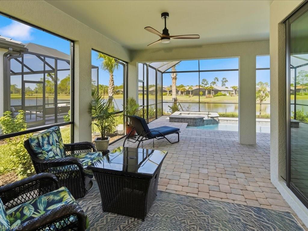 1937 Don Benito Way Naples, FL 34120 - Photo 9 of 27 Sunroom / solarium featuring a jacuzzi, ceiling fan, a water view, and a residential view