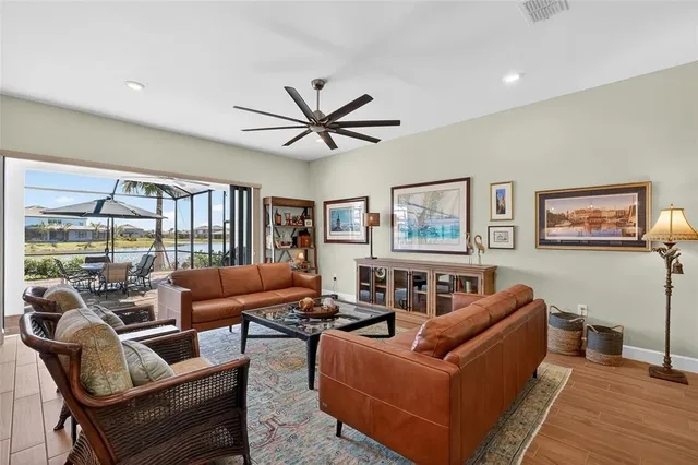 a living room with furniture and a wooden floor