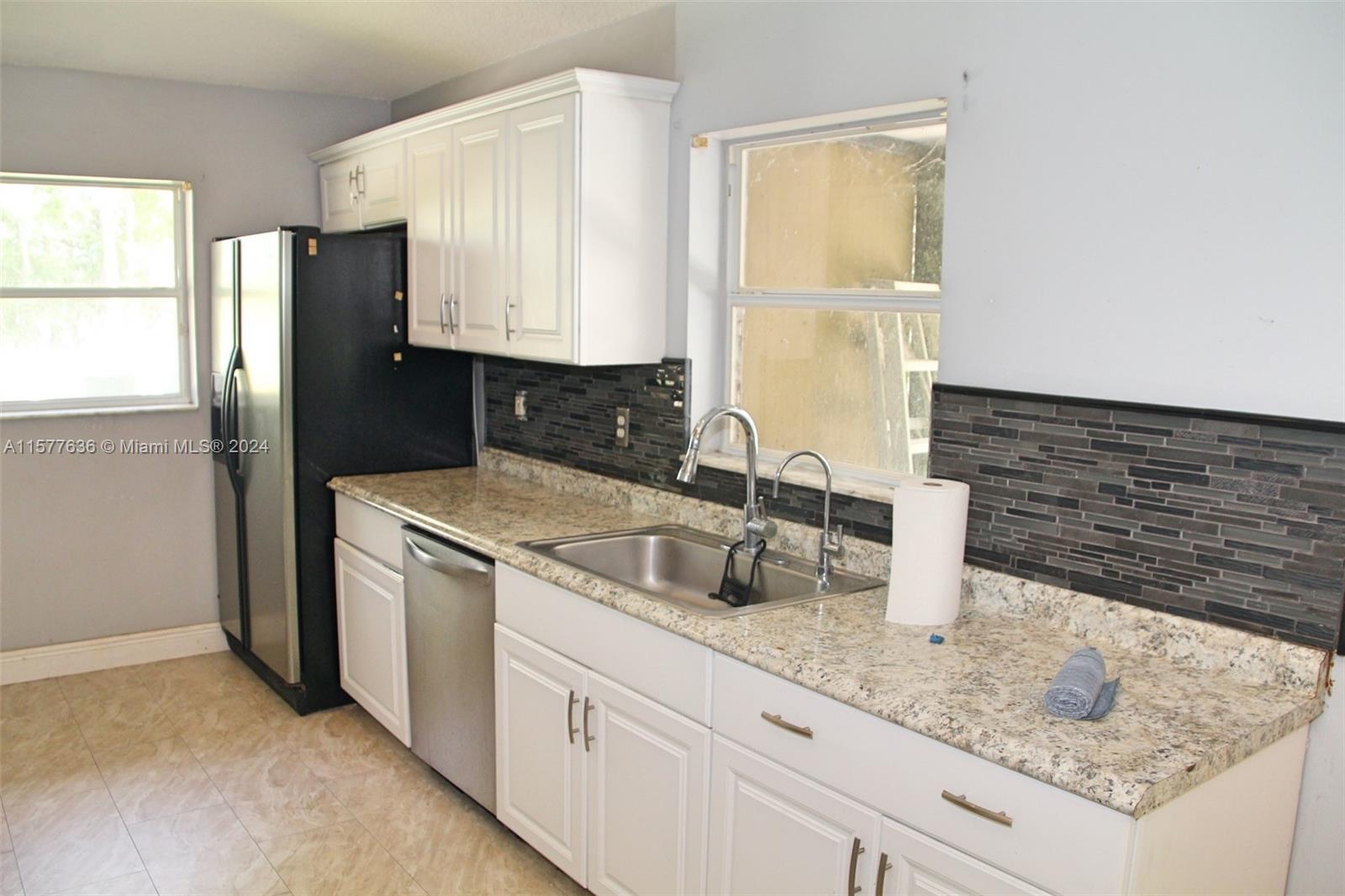 12646 55th Road North West Palm Beach, FL 33411 - Photo 3 of 10 a kitchen with a sink a refrigerator and window