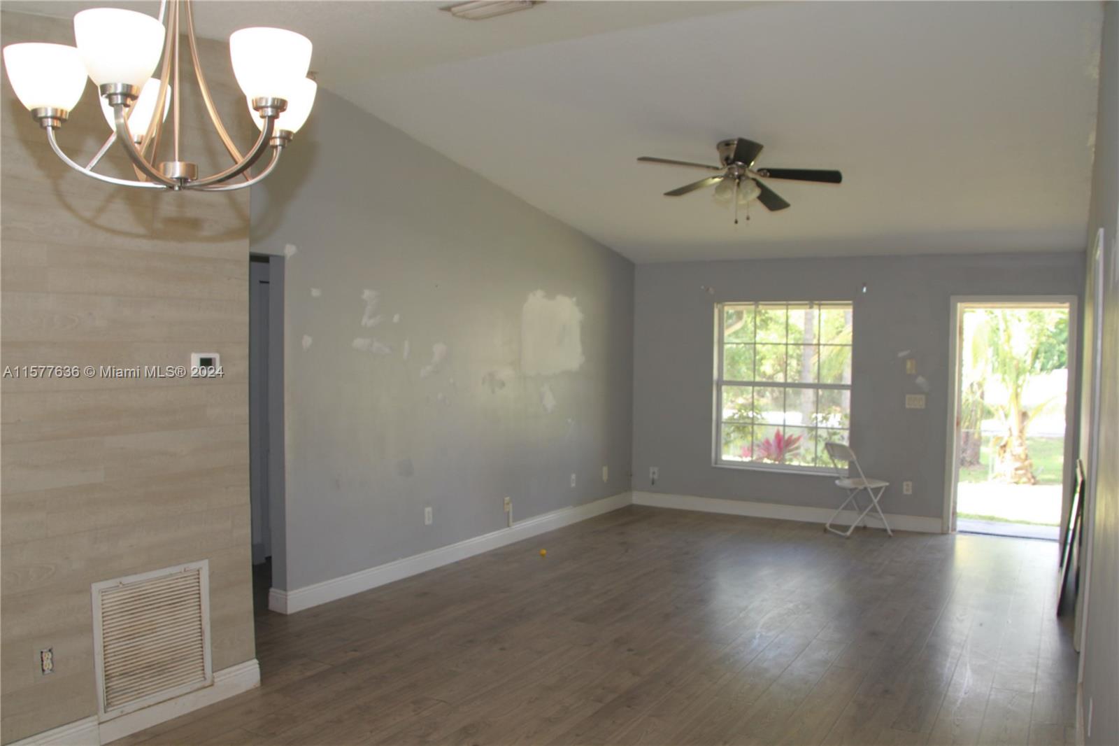 12646 55th Road North West Palm Beach, FL 33411 - Photo 5 of 10 wooden floor in an empty room with a window