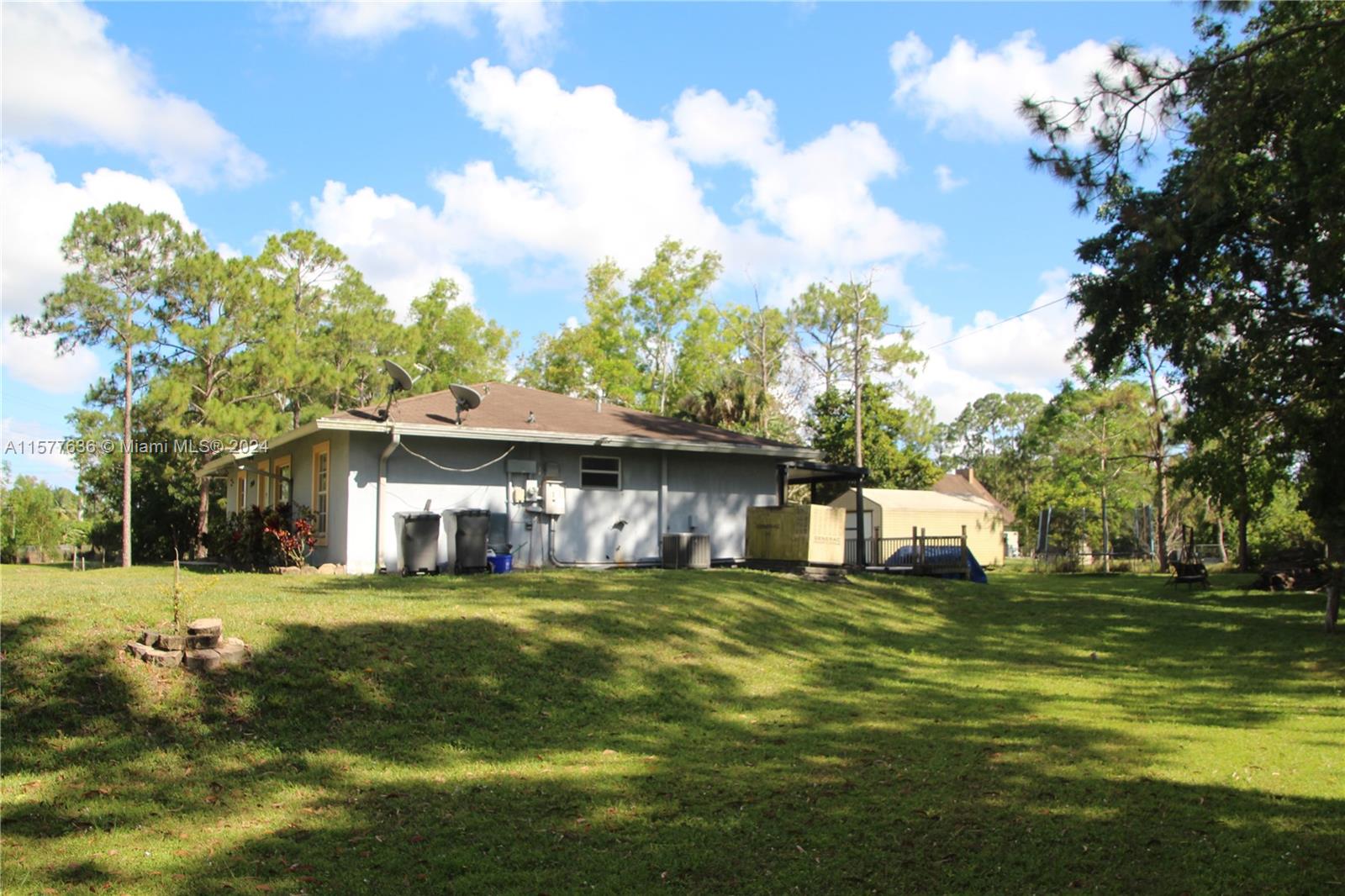 12646 55th Road North West Palm Beach, FL 33411 - Photo 7 of 10 a view of a house with a big yard