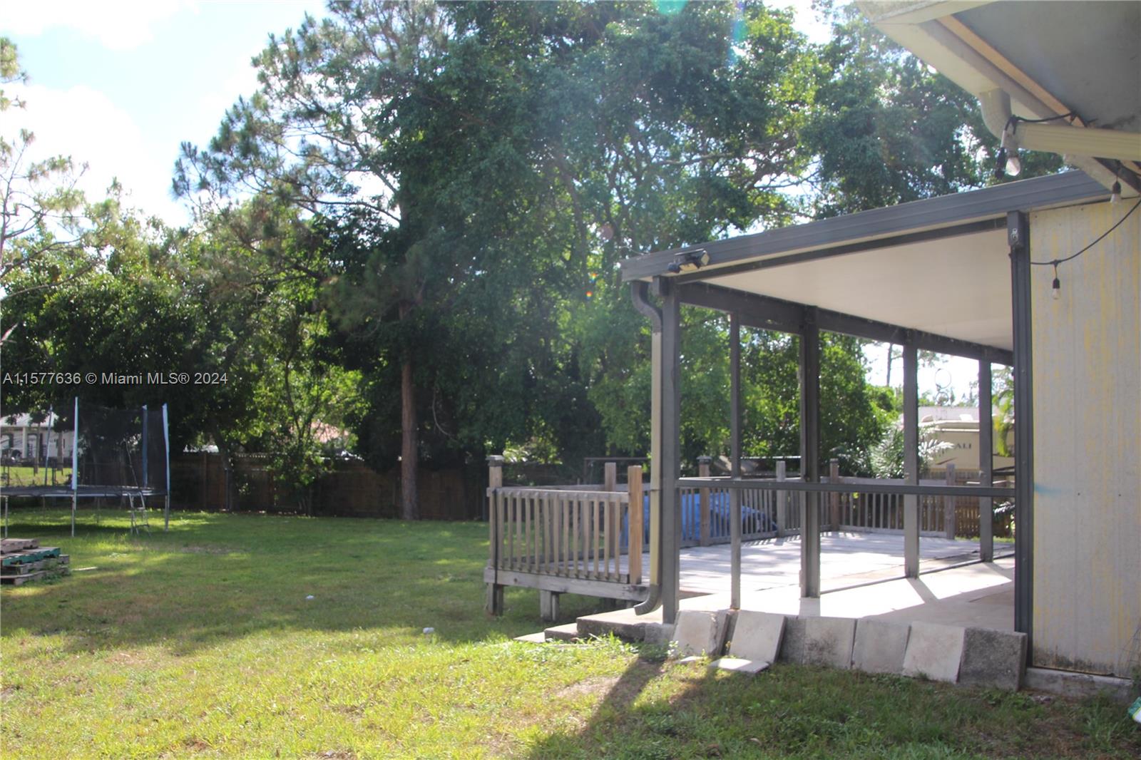 12646 55th Road North West Palm Beach, FL 33411 - Photo 8 of 10 a view of a backyard with a small cabin