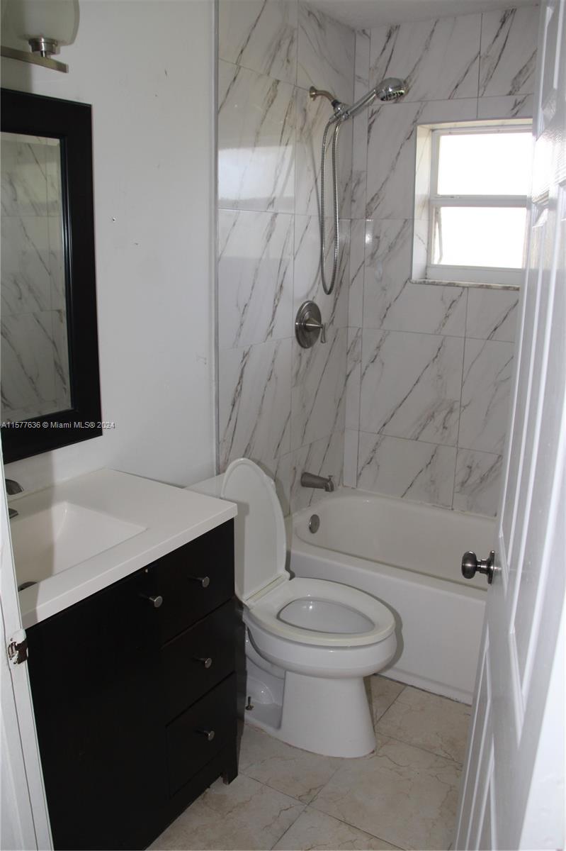 12646 55th Road North West Palm Beach, FL 33411 - Photo 9 of 10 a bathroom with a sink a toilet and shower