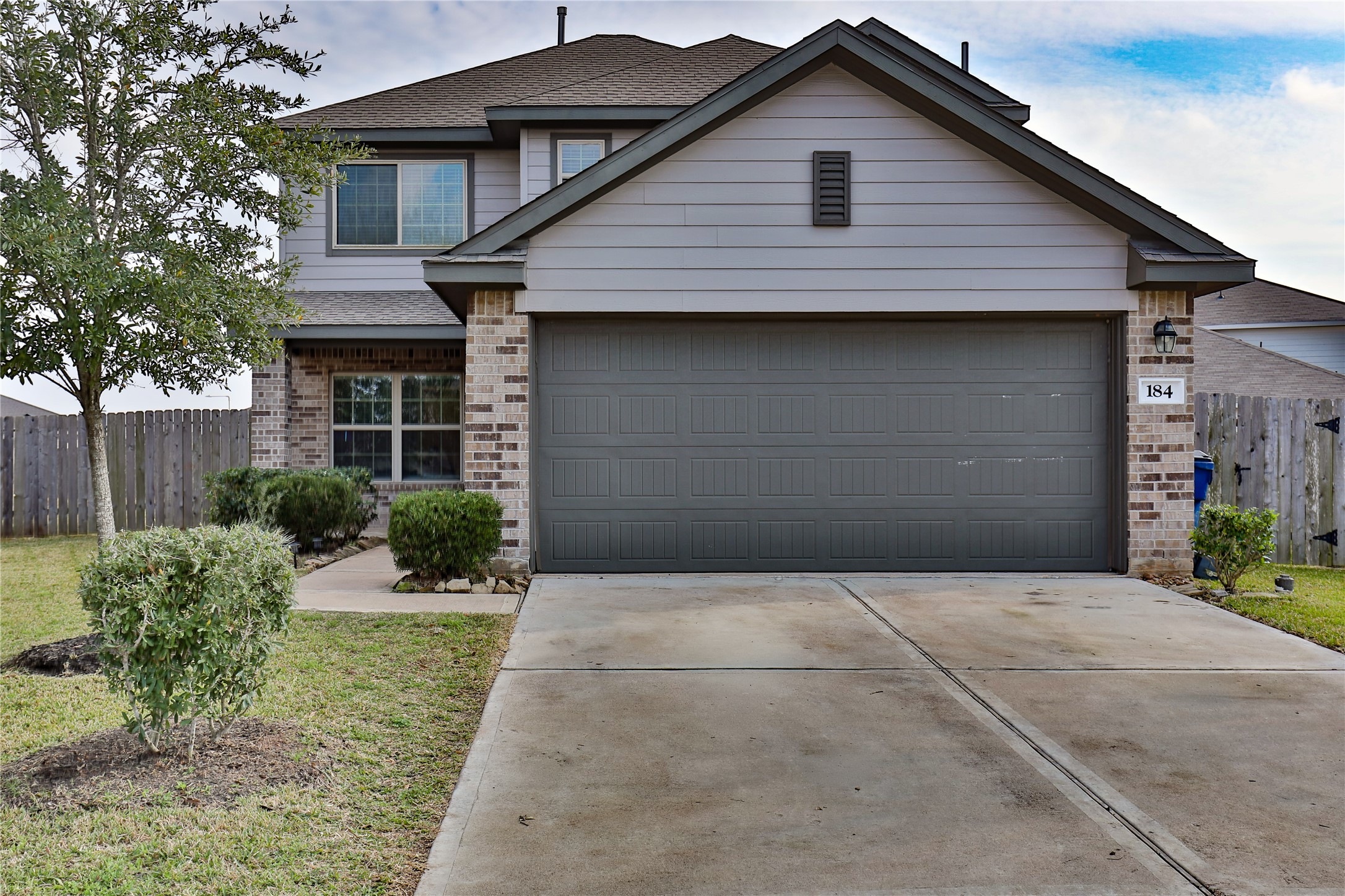 184 Kelly Street Angleton, TX 77515 - Photo 1 of 29 a front view of a house with garden