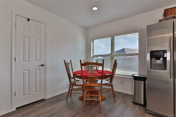 a view of a dining room with furniture and wooden floor