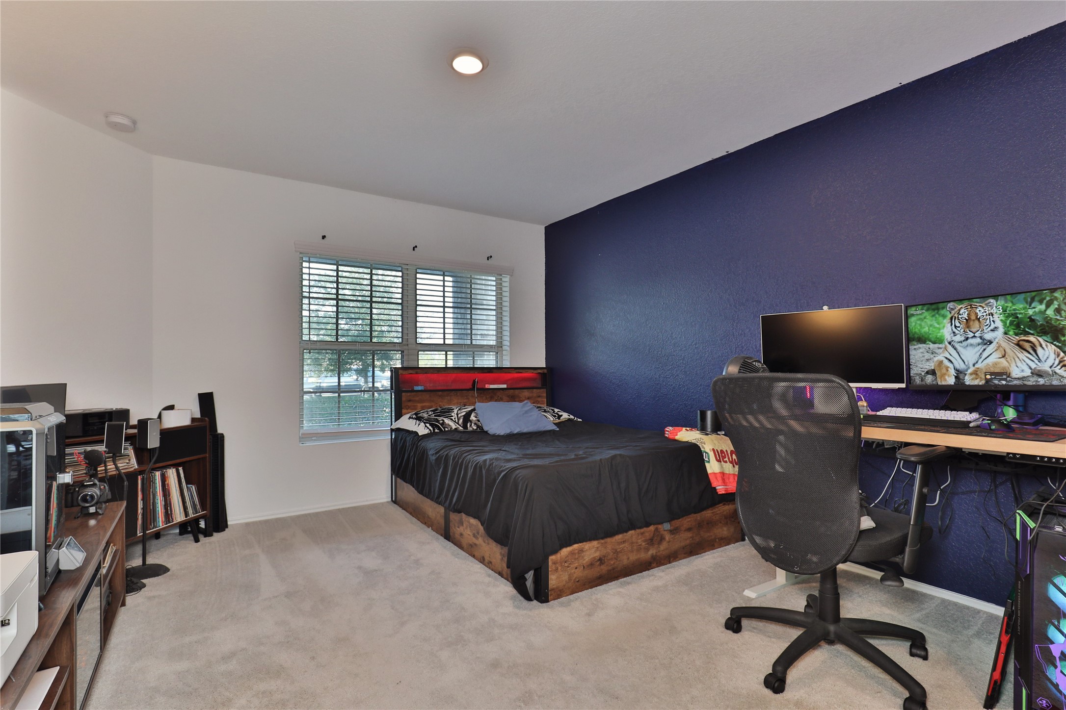 184 Kelly Street Angleton, TX 77515 - Photo 12 of 29 a bedroom with furniture and a window