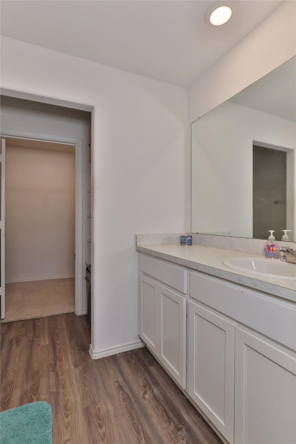 184 Kelly Street Angleton, TX 77515 - Photo 14 of 29 a bathroom with a sink and a mirror