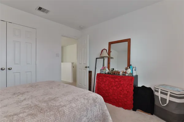 a bedroom with a bed and dresser