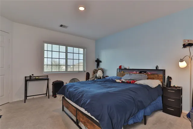 a bed room with a bed and a tv