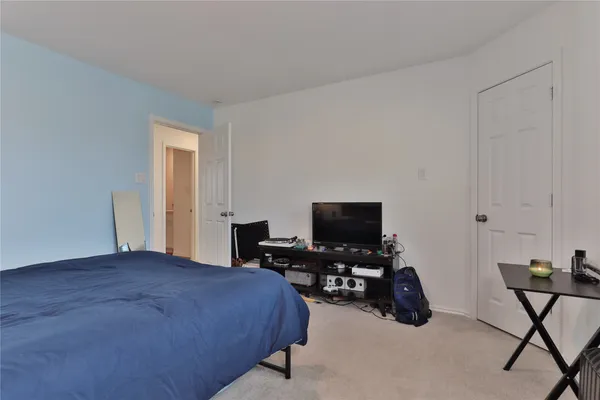 a bedroom with a bed and a chair