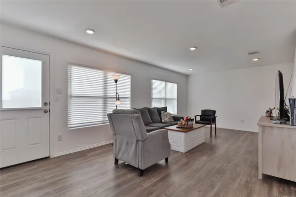 a living room with furniture window and wooden floor