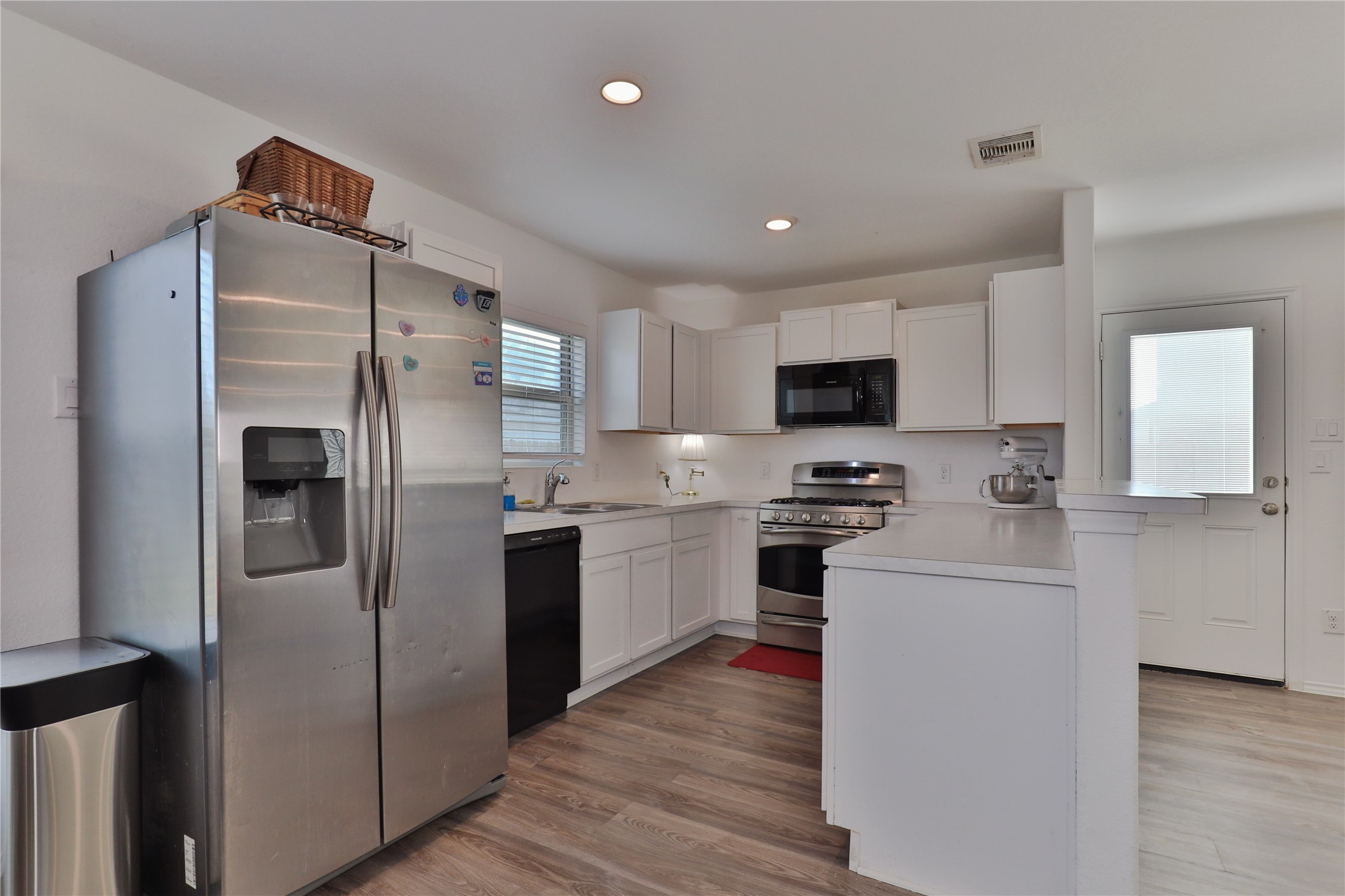 184 Kelly Street Angleton, TX 77515 - Photo 8 of 29 a kitchen with stainless steel appliances a refrigerator stove microwave and sink