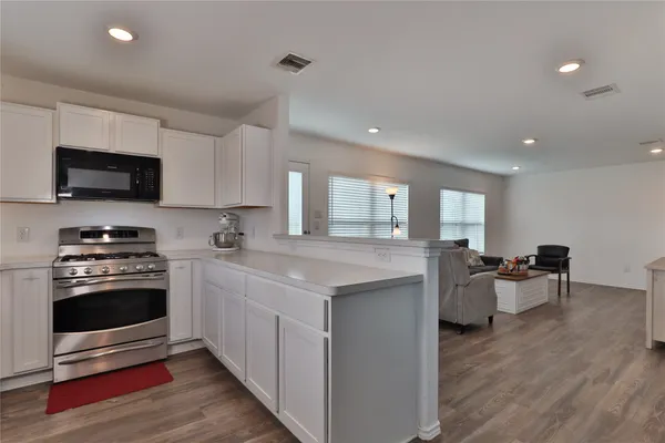 a kitchen with a sink and stove top oven