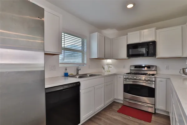 a kitchen with a sink stove and microwave