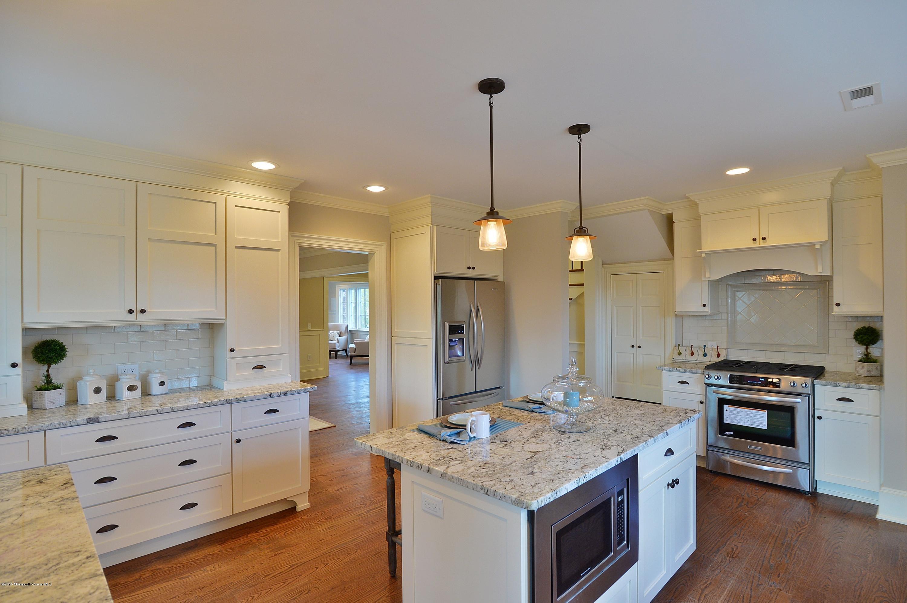 38 Silverside Avenue Little Silver, NJ 07739 - Photo 13 of 36 a kitchen with granite countertop a stove a sink a center island and cabinets