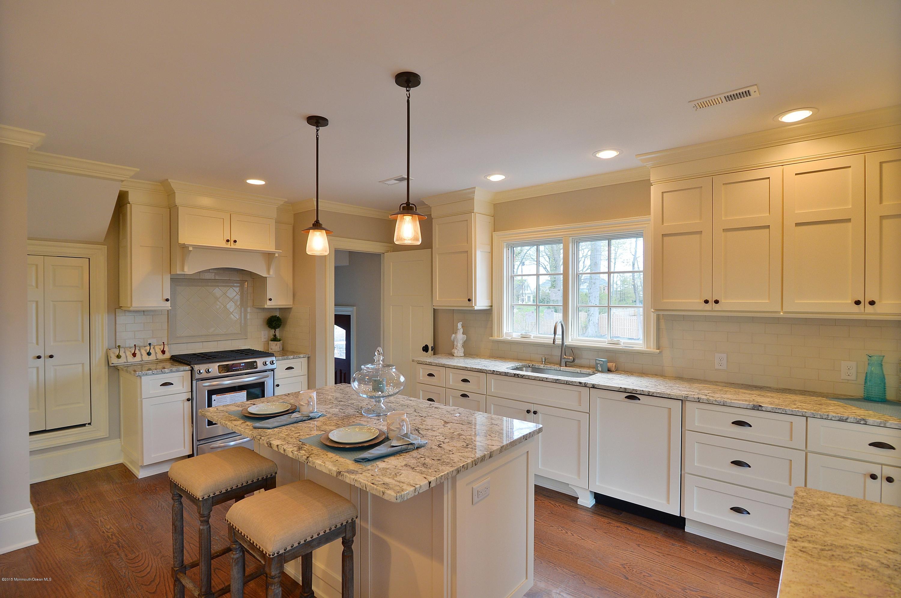 38 Silverside Avenue Little Silver, NJ 07739 - Photo 16 of 36 a kitchen with kitchen island granite countertop a sink counter top space and stainless steel appliances