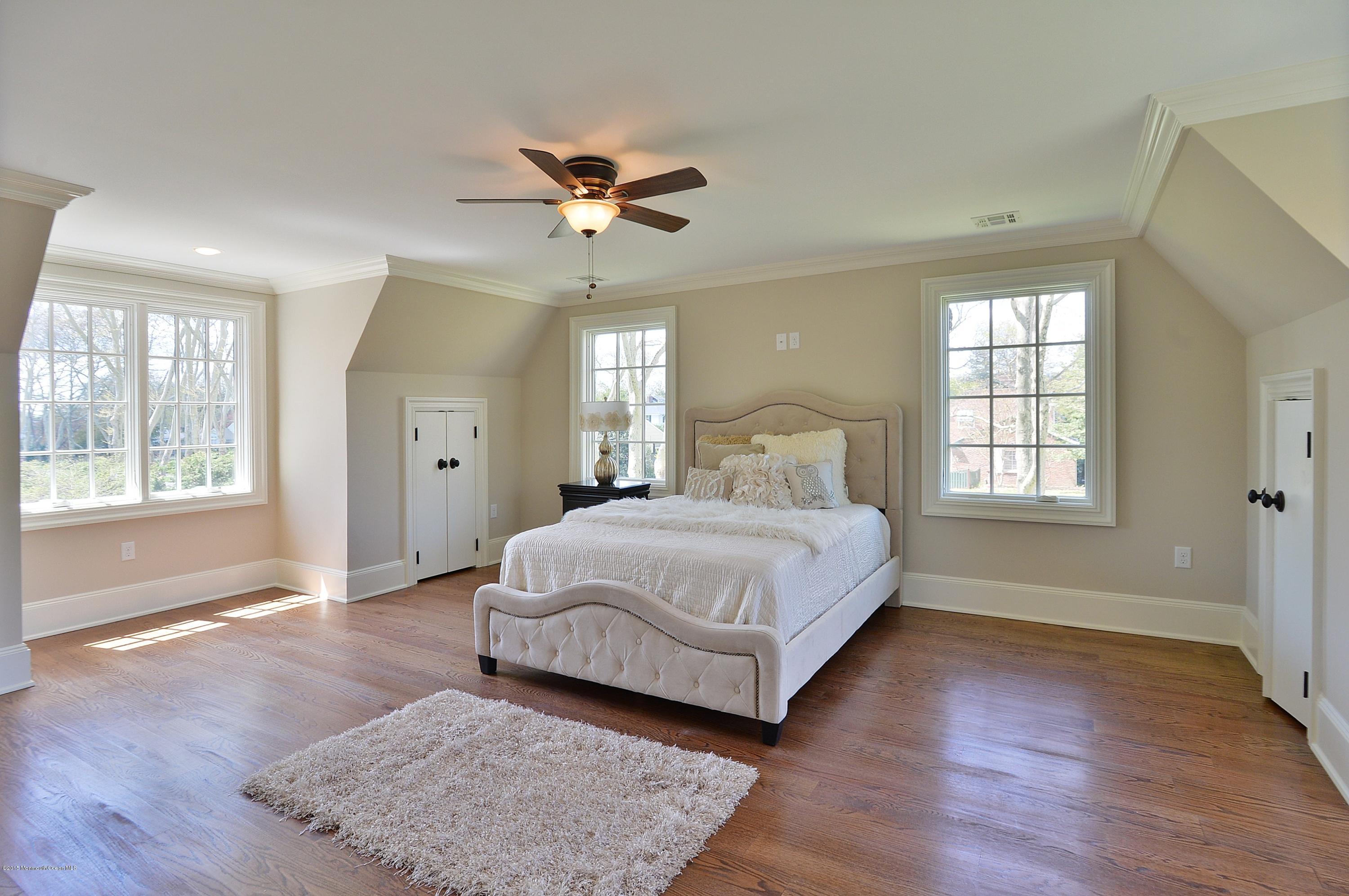 38 Silverside Avenue Little Silver, NJ 07739 - Photo 19 of 36 a spacious bedroom with a large bed wooden floor and window