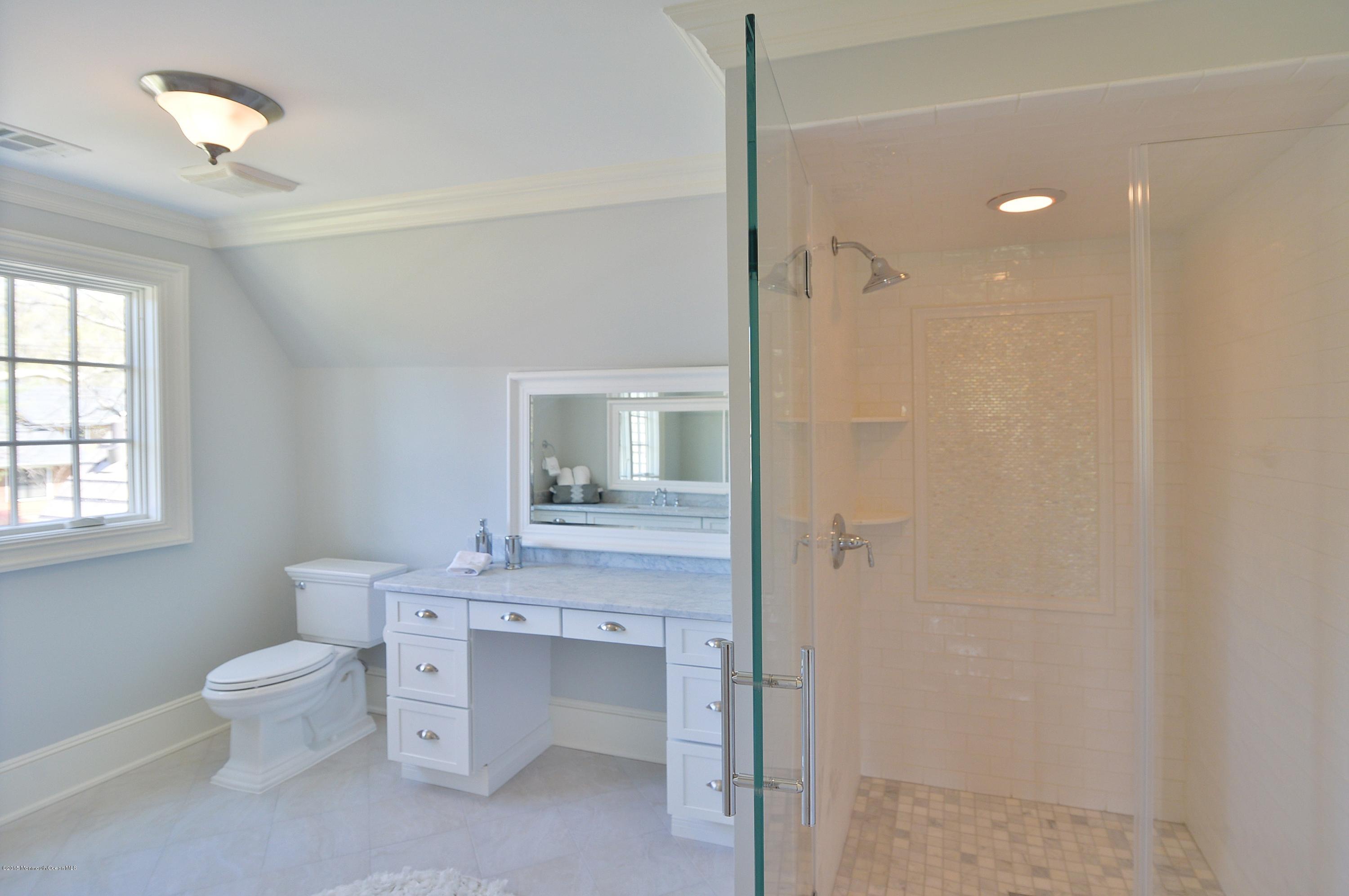 38 Silverside Avenue Little Silver, NJ 07739 - Photo 22 of 36 a bathroom with a granite countertop sink a toilet and shower