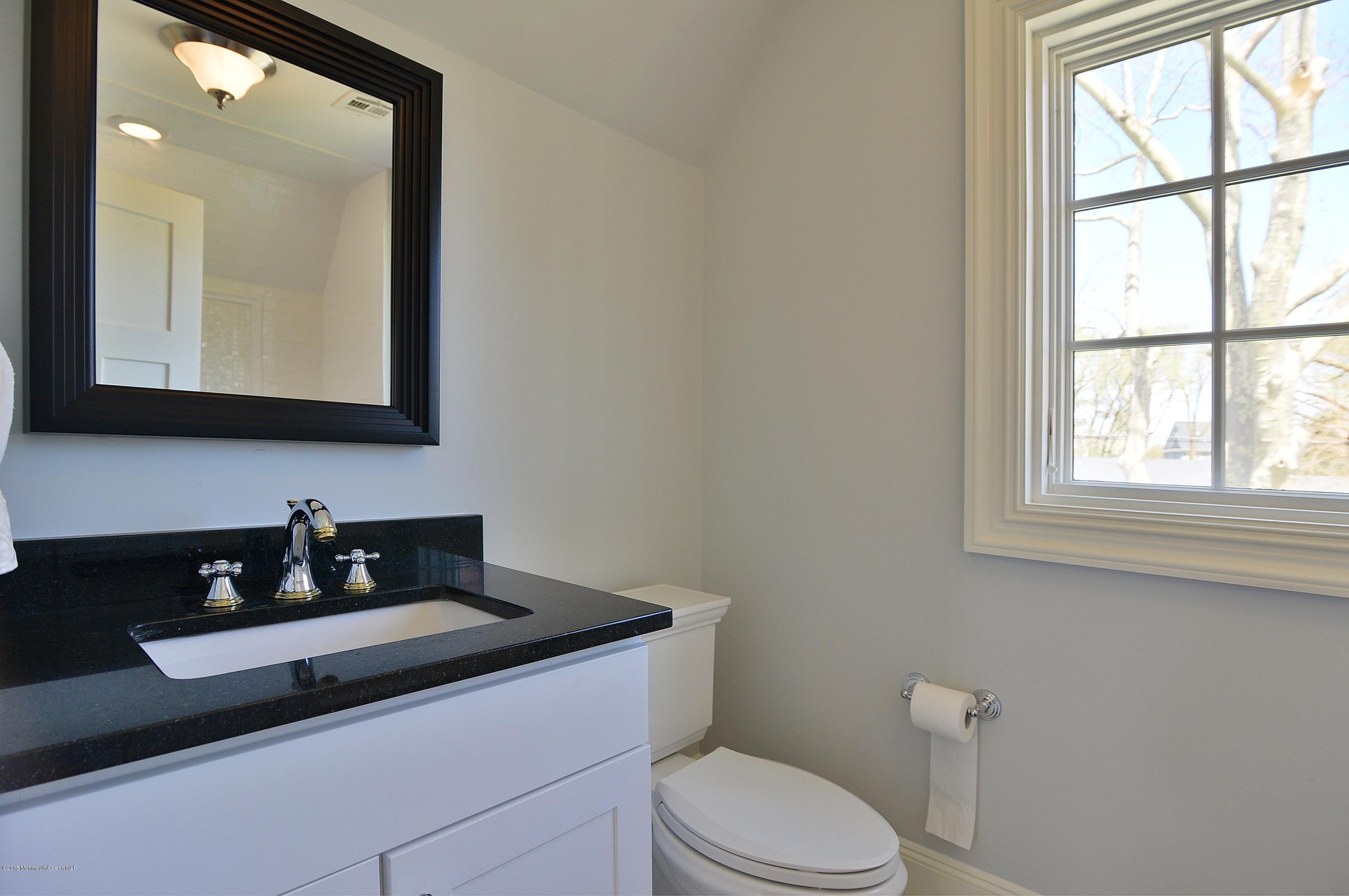 38 Silverside Avenue Little Silver, NJ 07739 - Photo 24 of 36 a bathroom with a toilet a sink a mirror and a window