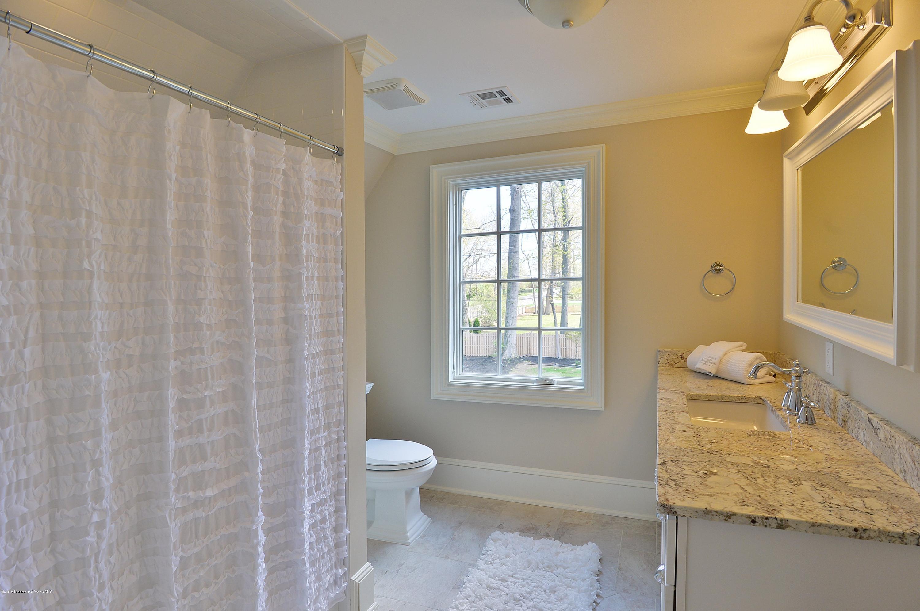 38 Silverside Avenue Little Silver, NJ 07739 - Photo 27 of 36 a bathroom with a granite countertop sink and a mirror