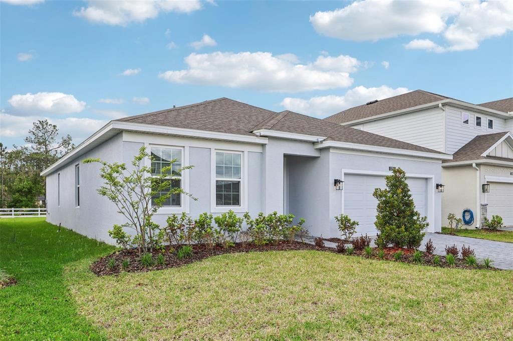 1756 Columbus Path St. Cloud, FL 34771 - Photo 2 of 37 a front view of house with a garden