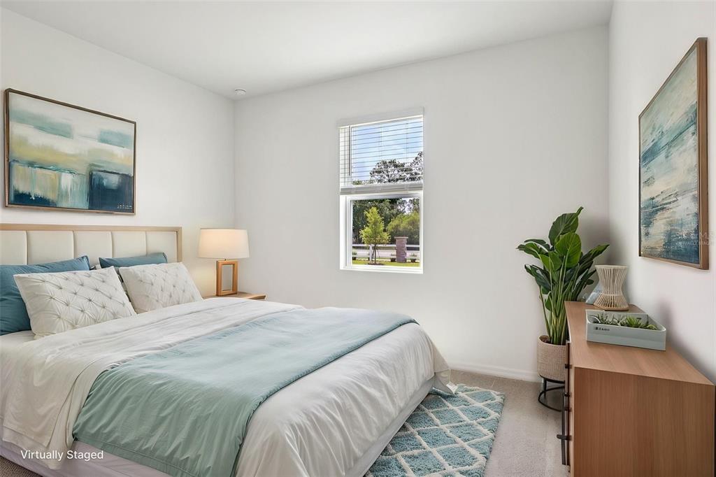 1756 Columbus Path St. Cloud, FL 34771 - Photo 21 of 37 a bedroom with a bed and a potted plant