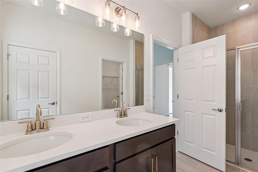1756 Columbus Path St. Cloud, FL 34771 - Photo 22 of 37 a bathroom with a sink and a mirror