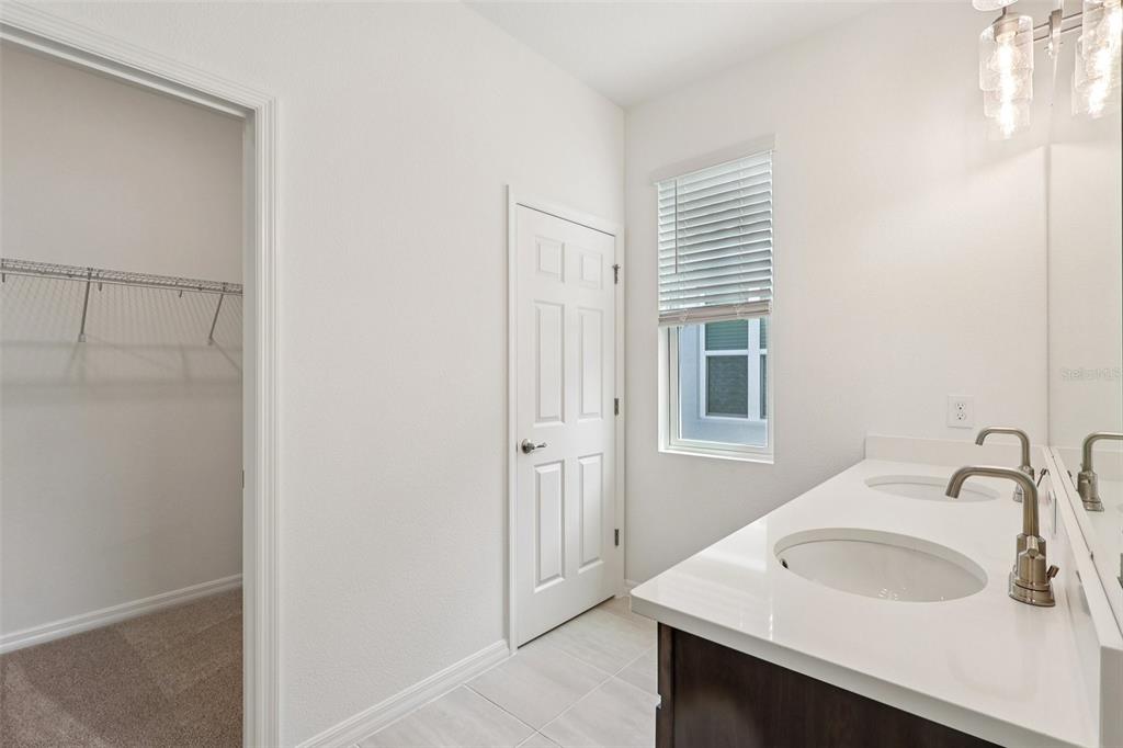 1756 Columbus Path St. Cloud, FL 34771 - Photo 23 of 37 a bathroom with a sink and a mirror