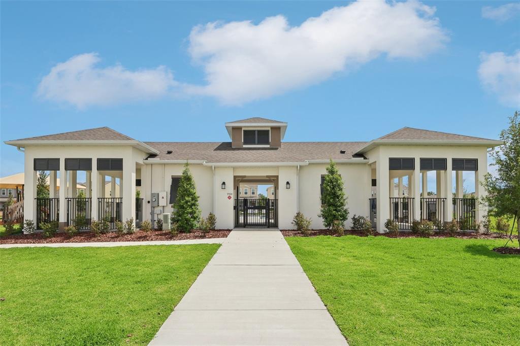 1756 Columbus Path St. Cloud, FL 34771 - Photo 31 of 37 a front view of a house with a yard and fountain