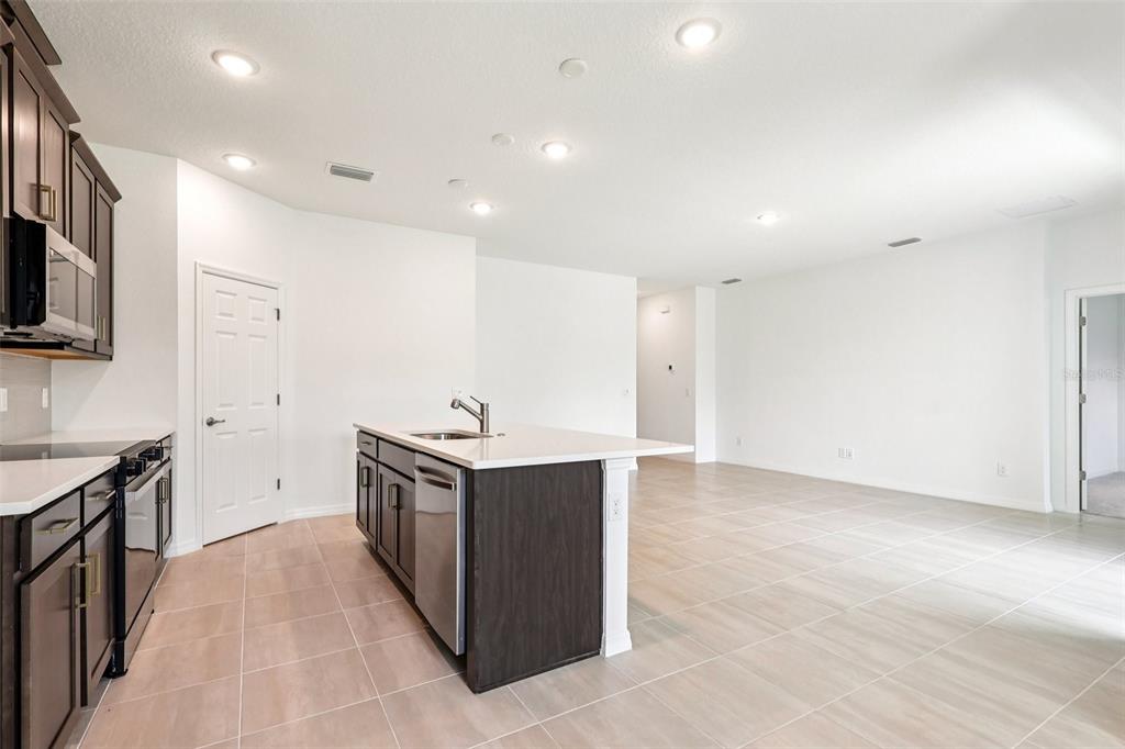 1756 Columbus Path St. Cloud, FL 34771 - Photo 7 of 37 a kitchen with stainless steel appliances a stove and a sink