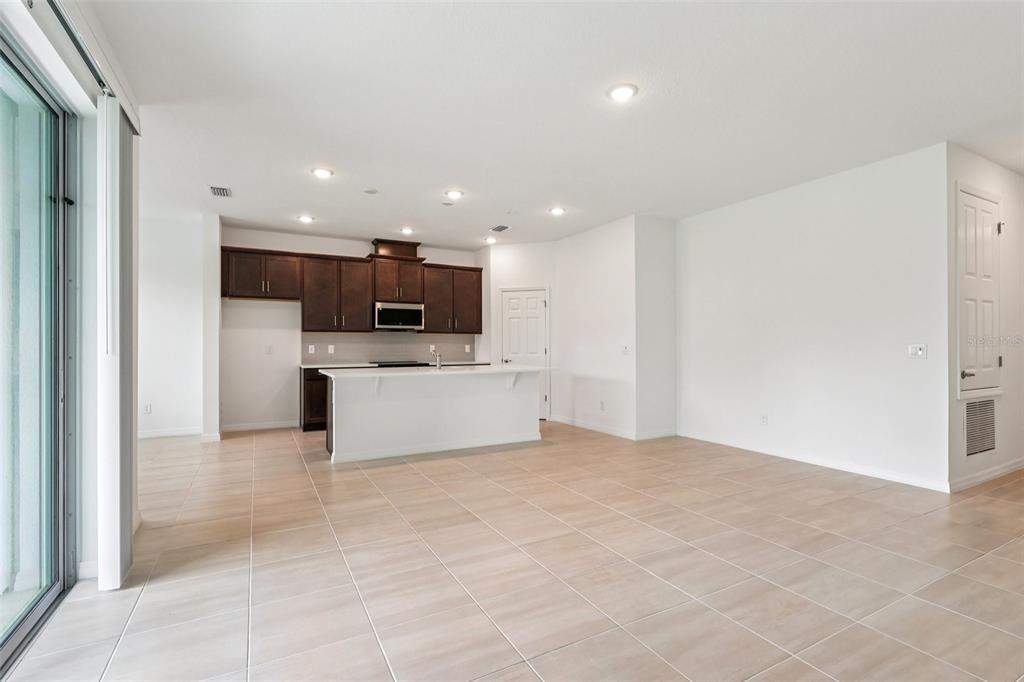 1756 Columbus Path St. Cloud, FL 34771 - Photo 10 of 37 a view of kitchen with kitchen island a sink stainless steel appliances and cabinets