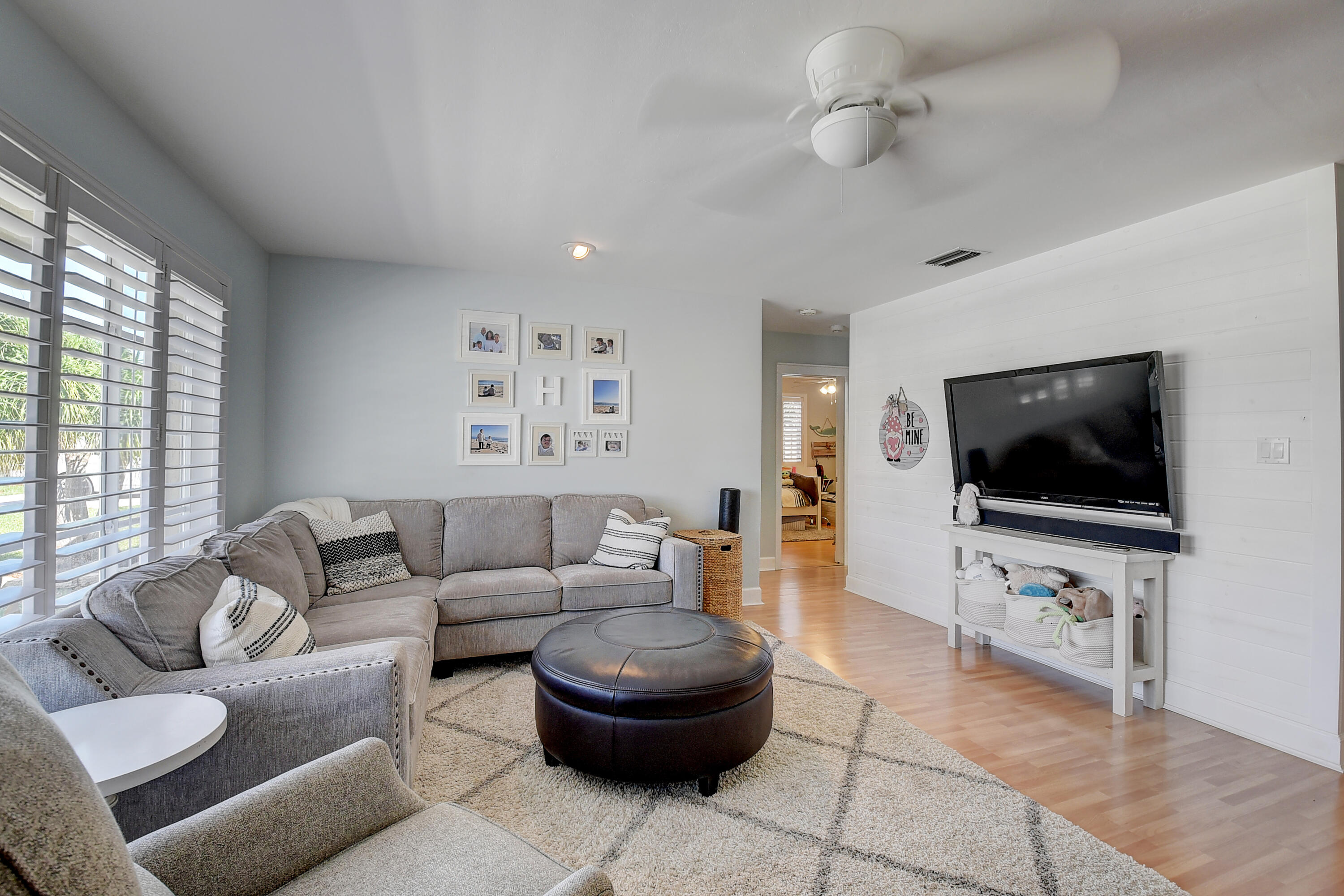 125 Riley Avenue Palm Springs, FL 33461 - Photo 3 of 24 a living room with furniture and a flat screen tv