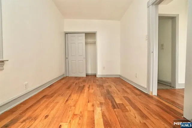 a view of a room with wooden floor and white doors