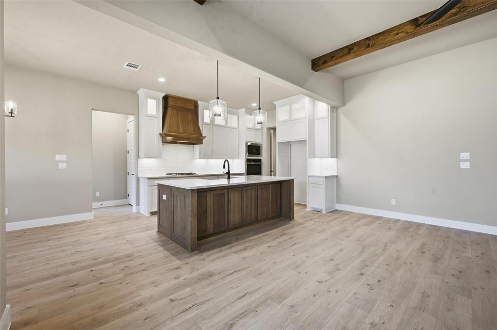 1053 Llano Way Poolville, TX 76487 - Photo 11 of 40 a large kitchen with a large counter top and stainless steel appliances