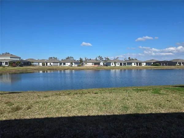 a view of a lake with houses in the back