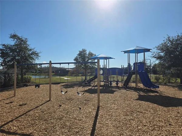 a view of a park with swings and slides