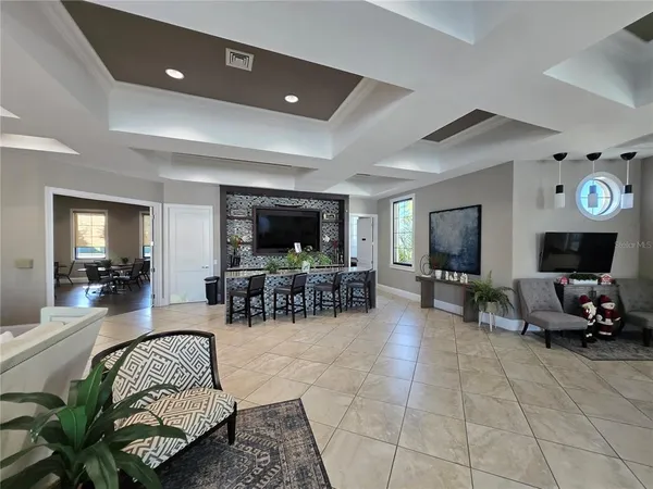 a living room with furniture and a flat screen tv with wooden floor