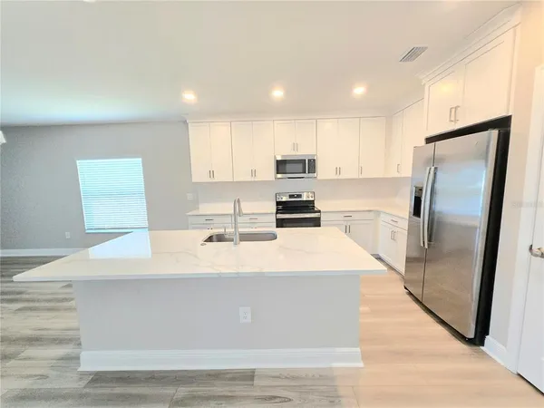 a large kitchen with stainless steel appliances