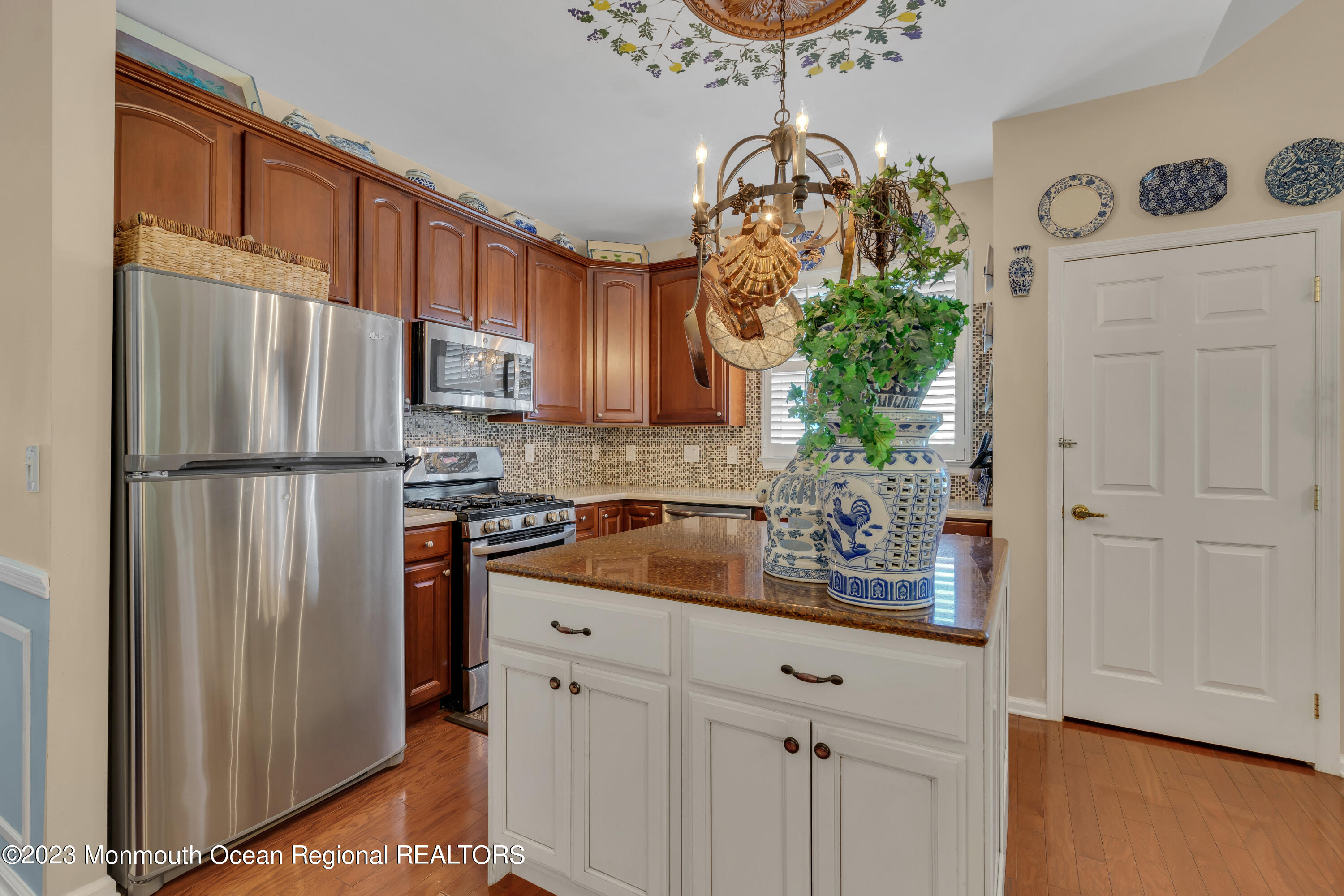 92 Pancoast Road Waretown, NJ 08758 - Photo 14 of 50 a kitchen with stainless steel appliances granite countertop a refrigerator a stove a sink and dishwasher with wooden floor