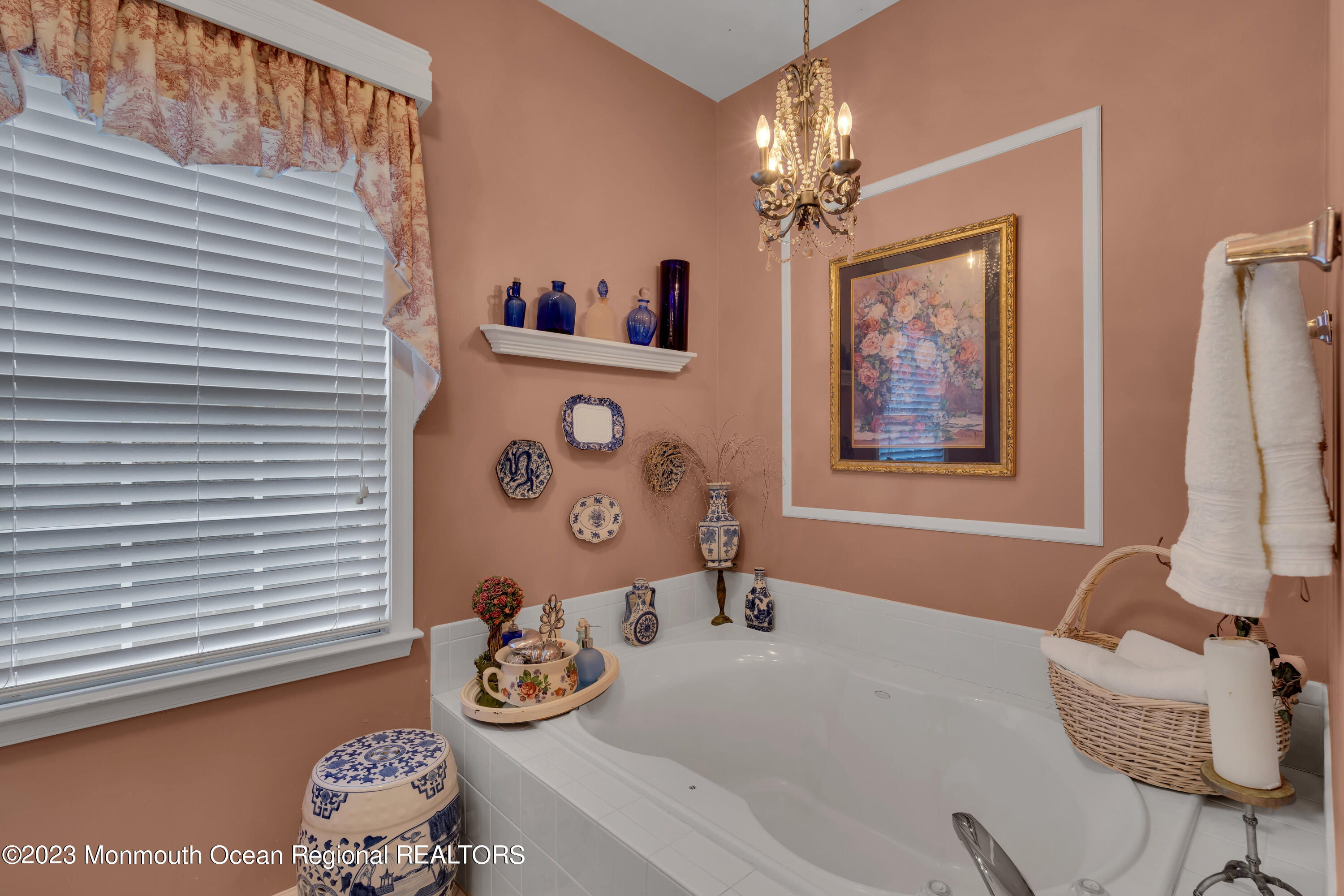 92 Pancoast Road Waretown, NJ 08758 - Photo 29 of 50 a bedroom with a bed and a chandelier