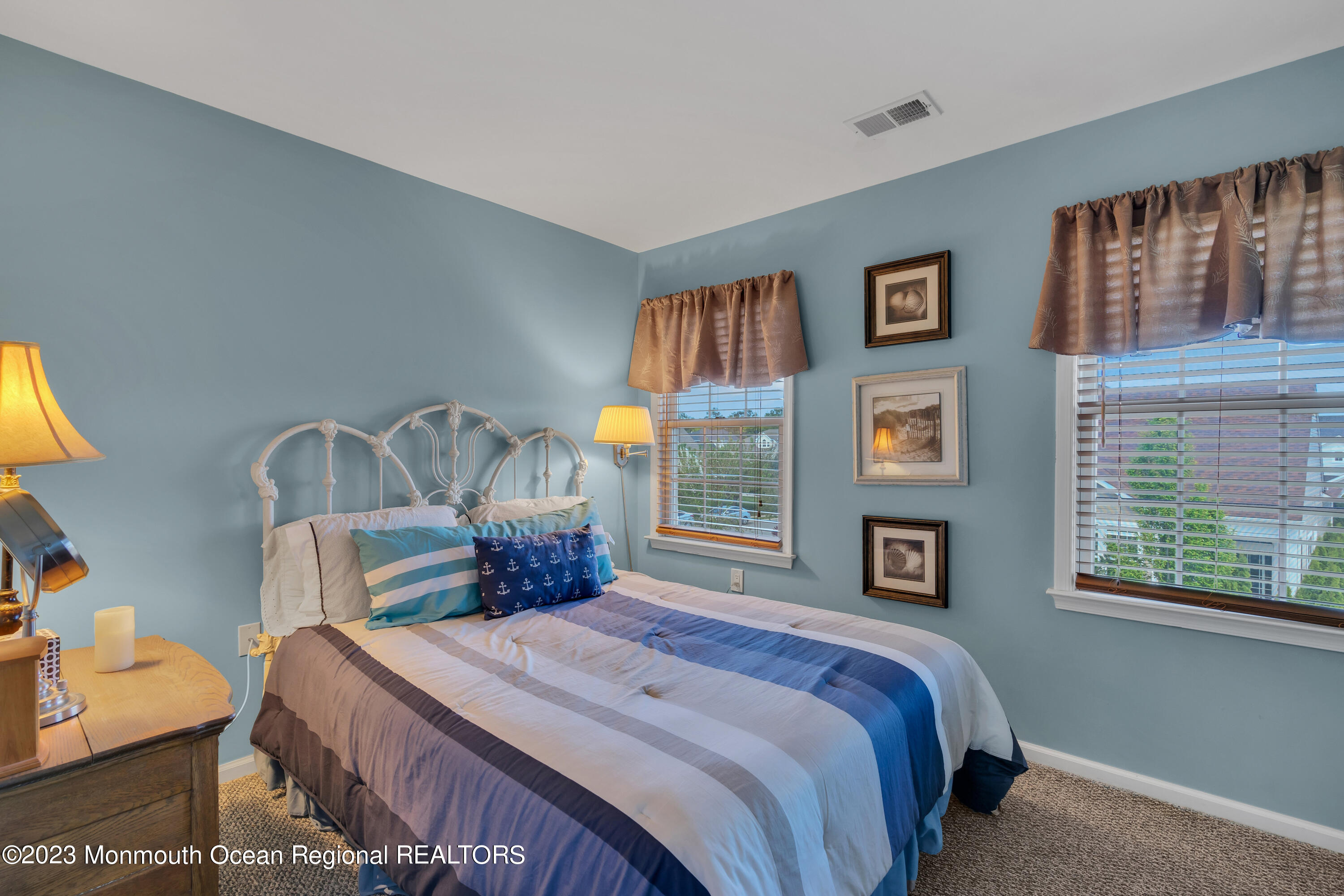 92 Pancoast Road Waretown, NJ 08758 - Photo 33 of 50 a bedroom with a bed next to a window with a book shelf