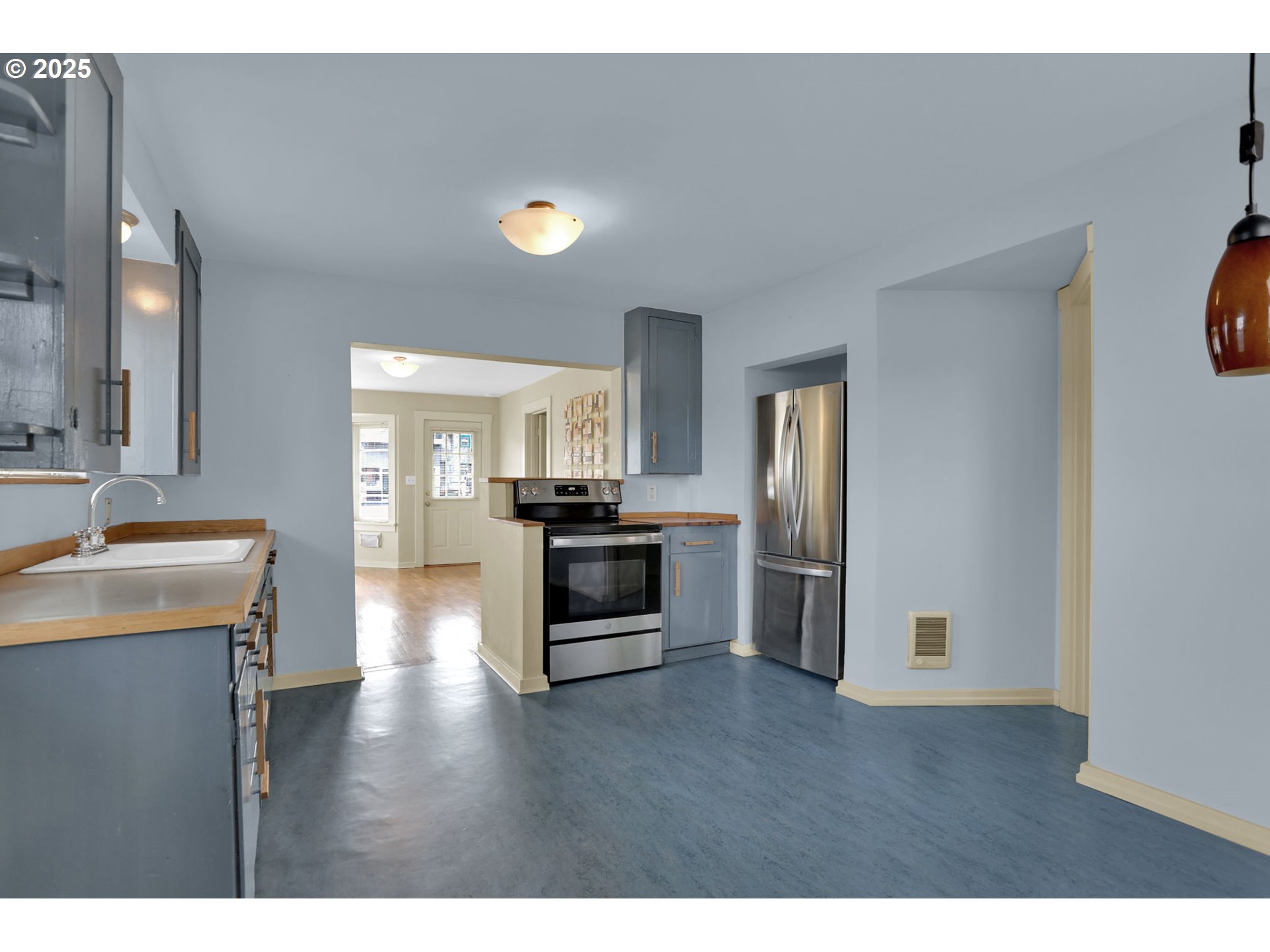 728 East Whiteaker Avenue Cottage Grove, OR 97424 - Photo 13 of 38 a kitchen with a refrigerator and a stove top oven