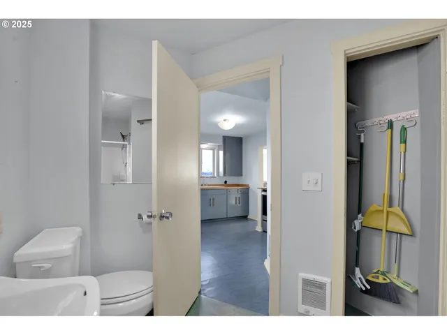 a bathroom with a toilet and a shower